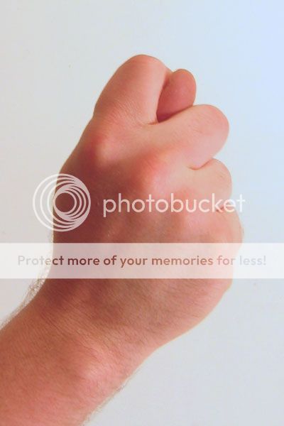 photo Gesture_fist_with_thumb_through_fingers_zpsb92fffbc.jpg